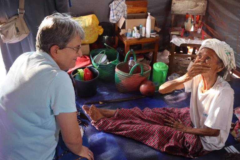 Sr. Miriam visits one of the volcano eruption survivors.